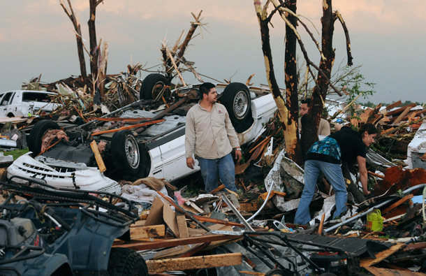 Residents begin digging through the rubble of their home after it was destroyed by a tornado that hit Joplin, Mo. The tornado tore a path a mile wide and four miles long destroying homes and businesses. (AP)