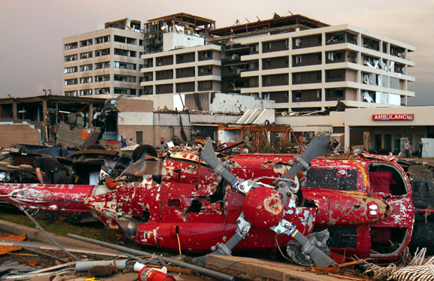 A destroyed helicopter lies on its side in the parking lot of the Joplin Regional Medical Center in Joplin, Mo. A large tornado moved through much of the city, damaging the hospital and hundreds of homes and businesses. (AP)