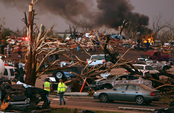 Emergency personnel walk through a neighborhood severely damaged by a tornado near the Joplin Regional Medical Center in Joplin, Mo. A large tornado moved through much of the city, damaging a hospital and hundreds of homes and businesses. (AP)