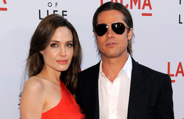 Brad Pitt, right, a cast member in "The Tree of Life," poses with his wife, actress Angelina Jolie, at a screening of the film, in Los Angeles. (AP)