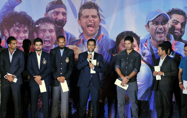 Indian cricket team captain Mahendra Singh Dhoni speaks (C) onstage while accompanied by his teammates during the BCCI Awards 2009-2010 function in Mumbai. (AFP)