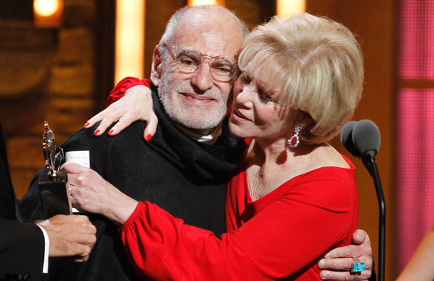 Larry Kramer, left, is hugged by Daryl Roth after they won the Tony Award for Best Revival of a Play for "The Normal Heart" during the 65th annual Tony Awards in New York. (AP)