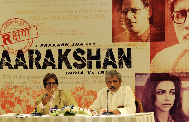 Indian Bollywood actor Amitabh Bachchan (L) and director Prakash Jha (R) address media representatives in New Delhi during a promotional event for their forthcoming film 'Aarakshan' (Reservation). (AFP)