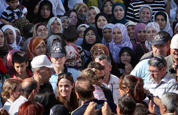 Angelina Jolie, Hollywood actress and goodwill ambassador for the U.N. High Commissioner for Refugees, UNHCR, is surrounded by Syrian refugees at the Altinozu refugee camp, Turkey, near the Syrian border. (AP)