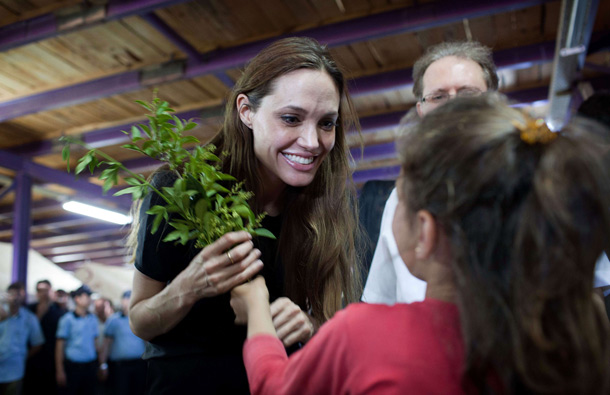 United Nations High Commissioner for Refugees (UNHCR) Goodwill Ambassador Angelina Jolie (C) meets a young Syrian refugee girl at the Altinozu camp in the Hatay province of Turkey, 20km from the Syria border, accompanied by UNHCR staff and Turkish government officials. (AFP)