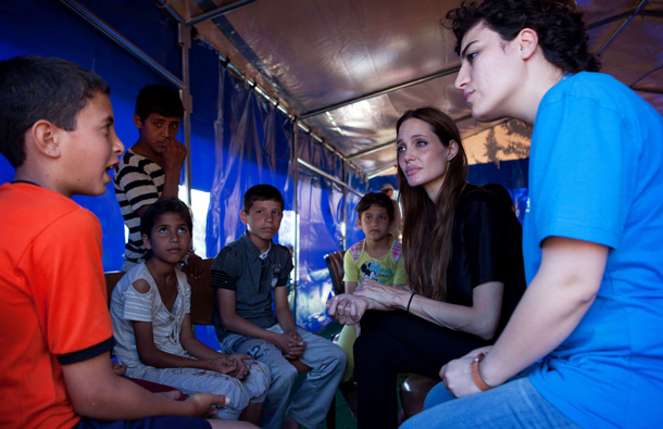 United Nations High Commissioner for Refugees (UNHCR) Goodwill Ambassador Angelina Jolie (2nd R) listens to a Syrian refugee boy talk at the Altinozu camp in the Hatay province of Turkey, 20km from the Syria border, accompanied by UNHCR staff and Turkish government officials. (AFP)