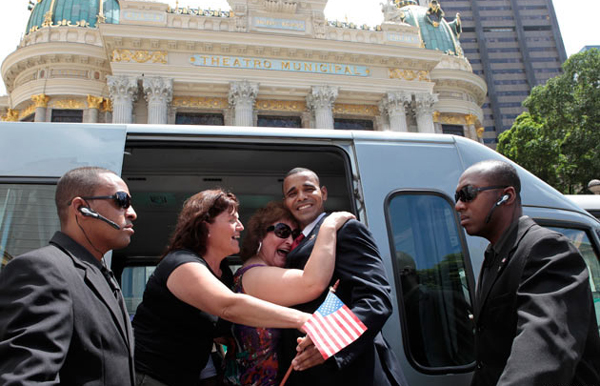 US President Barack Obama impersonator, Rinaldo Americo, is greeted by tourists in Cinelandia Square in Rio de Janeiro. (REUTERS)