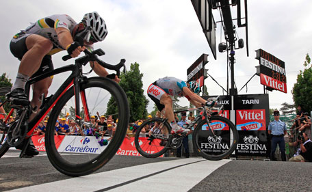 Andre Greipel of Germany, rear, pushes his wheel over the finish line ahead of second place Mark Cavendish of Britain, left, to win the 10th stage of the Tour de France cycling race over 158 kilometers (98.2 miles) starting in Aurillac and finishing in Carmaux, south central France, Tuesday July 12, 2011. (AP)