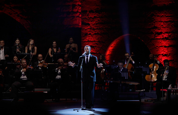 Iraqi singer Kazem al-Saher, center, performs during a concert in the historic Beiteddine Palace in Beiteddine near Beirut, Lebanon. (AP)