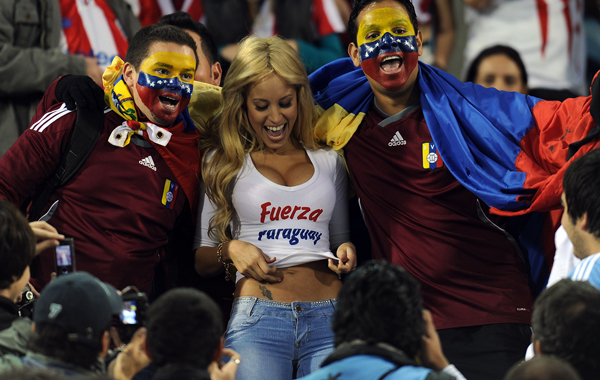 Venezuelan fans surround a Paraguayan fan before the start of a 2011 Copa America Group B first round football match, at the Padre Ernesto Martearena stadium in Salta, 1617 Km northwest of Buenos Aires. (AFP)