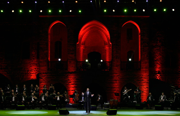 Iraqi singer Kazem al-Saher, center, performs during a concert in the historic Beiteddine Palace in Beiteddine, near Beirut, Lebanon. (AP)