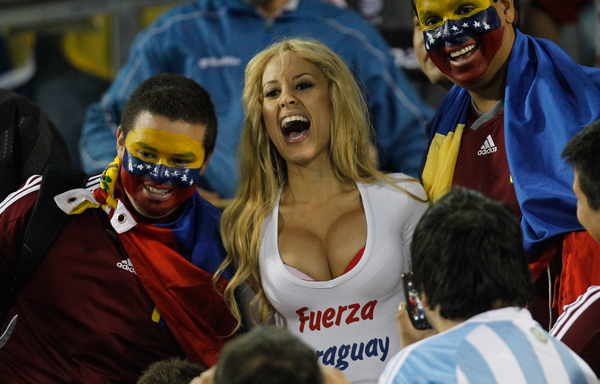 Venezuela's soccer fans pose for pictures with a Paraguayan fan, center, before the start of Group B Copa America soccer match between Venezuela and Paraguay in Salta, Argentina. (AP)