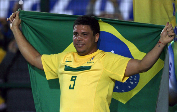 São Paolo, Brazil: Brazil's Ronaldo holds up a Brazilian flag during his last soccer match with the national squad against Romania in Pacaembu Stadium in Sao Paulo. (REUTERS)