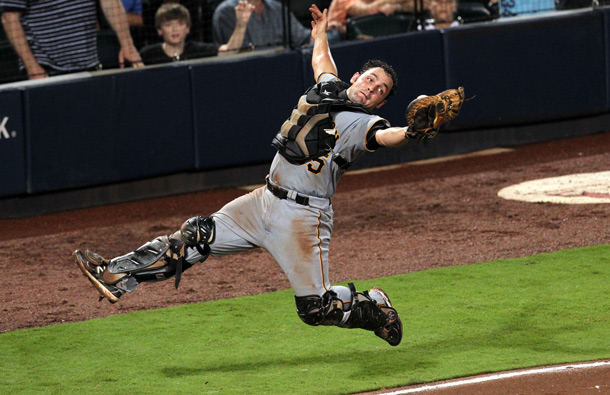 Pittsburgh Pirates catcher Michael McKenry leaps to catch a pop fly by Atlanta Braves Nate McLouth in the sixth inning of their game at Turner Field Monday night in Atlanta, Ga. The Braves lost to the Pirates 3-1. (AP)