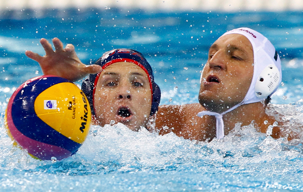 Anthony Azevedo (L) of the U.S. fights Hungary's Gergely Kiss for the ball during their men's water polo quarter-final match at the 14th FINA World Championships in Shanghai. (REUTERS)