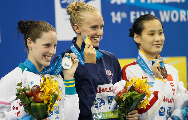 Dana Vollmer, center, of the U.S. shows her gold medal with Australia's Alicia Coutts, left, silver, and China's Lu Ying, bronze, after the women's 100m Butterfly final at the FINA Swimming World Championships in Shanghai, China. (AP)