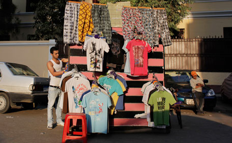 An Egyptian vendor displays clothes for sale at a street in Cairo, Egypt Wednesday, July 20, 2011. Egyptians are shopping in the streets of Cairo in preparation for the upcoming Muslim holy month of Ramadan beginning early August this year. (AP)