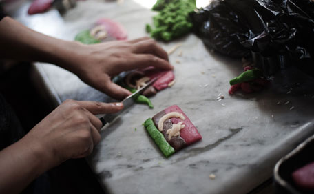 Libyan women bakers prepare pastry and sweets with the colours of the former Libyan flag used by the rebels, at a bakery in the Libyan rebel stronghold city of Benghazi on July 25, 2011. Civil war or not, every year the holy Muslim month of Ramadan must be respected and in Libya's rebel stronghold of Benghazi women bakers are working overtime to meet demand. (AFP)