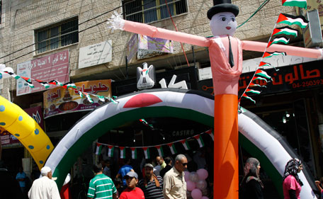 Palestinians shop in the market in preparation for the Muslim fasting holy month of Ramadan, which is set to begin in early August, in the Palestinians West Bank city of Jenin  Saturday, July 30, 2011. (AP)