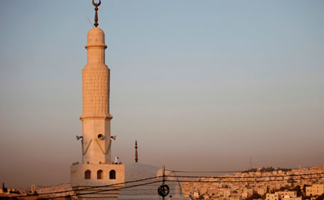 An Imam looks out from the terrace of a mosque minaret to observe the moon at sunset in Amman, Jordan, Saturday July 30, 2011. Jordan's Islamic Justice Department announced that Monday Aug. 1 will be the first day of Ramadan. (AP)