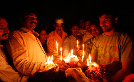 Supporters of Anna Hazare light candles as they stage a demonstration in his support in Allahabad, India, Monday, Aug. 15, 2011. (AP)