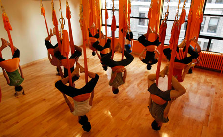 tudents hang upside down in hammocks as they take part in an "antigravity" yoga class at the Om Factory in New York August 16, 2011. "Antigravity" yoga makes use of hammocks to help practitioners gain greater flexibility, allowing for a wider range of yoga poses, according to the workshop's website.(REUTERS)