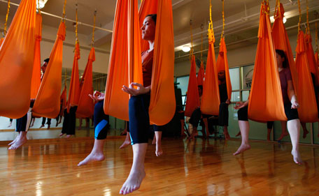 Student sit in hammocks as they take part in an "antigravity" yoga class at the Om Factory in New York August 16, 2011. "Antigravity" yoga makes use of hammocks to help practitioners gain greater flexibility, allowing for a wider range of yoga poses, according to the workshop's website.(REUTERS)