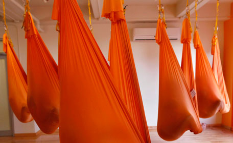 Students sit in hammocks as they take part in an "antigravity" yoga class at the Om Factory in New York August 16, 2011. "Antigravity" yoga makes use of hammocks to help practitioners gain greater flexibility, allowing for a wider range of yoga poses, according to the workshop's website.(REUTERS)