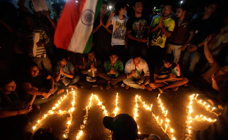 Supporters of Indian anti-corruption activist Anna Hazare gather around lighted candles outside the Tihar prison in New Delhi, India, Tuesday, Aug 16, 2011.Hazare, arrested Tuesday for planning a public hunger strike, began his fast behind bars as his supporters held protests nationwide, with thousands detained. Hazare was refusing to leave unless police allowed him to continue his hunger strike indefinitely in a New Delhi park. (AP)