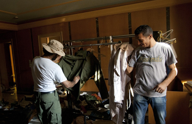 Rebel fighters try clothes in the house of Aisha Gaddafi. (AP)