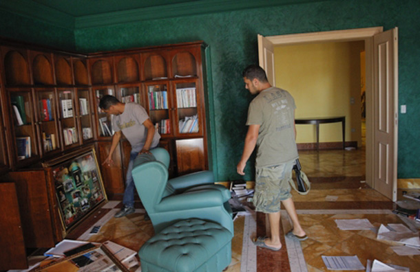 Rebel fighters seen inside the house of Aisha Gaddafi. (AP)