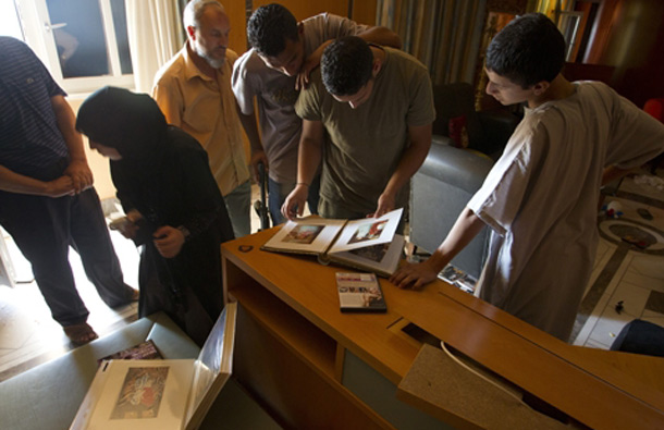 Rebel fighters and civillians seen inside the house of Aisha Gaddafi. (AP)