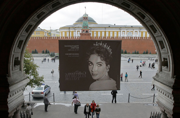 An advertisement of the Elizabeth Taylor collection pre-auction Christie's exhibition is seen at an entrance to Moscow's GUM department store. The Red Square is at the background. The auction will take place in December in New York. (AP)