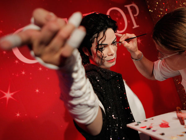 Figure production maintenance manager Petra van der Meer retouches Michael Jackson's wax figure at the Madame Tussauds exhibition in Tokyo, Japan, Wednesday, Sept. 28, 2011. A total of 17 life-size waxworks of world famous people will be displayed in Tokyo during a three-month exhibition from Sept. 30 until Jan. 4, 2012. (AP)