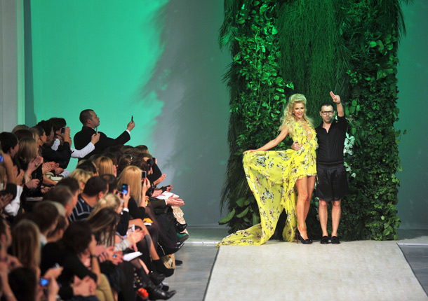 Paris Hilton displays a creation from a  collection by Ukrainian fashion designer Andre Tan (r) during Ukrainian Fashion Week show in Kiev. Some 40 popular Ukrainian fashion designers and  guests will show their work during the week. (AFP)