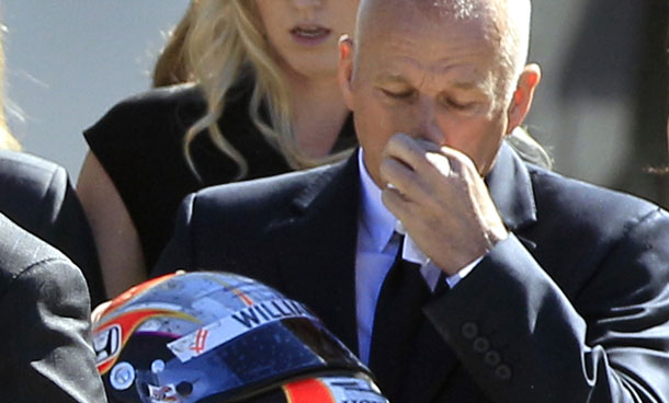 Clive Wheldon, right, father of IndyCar driver Dan Wheldon, wipes his face as he holds his son Dan's helmet after funeral services for Dan Wheldon, Saturday, Oct 22, 2011, in St. Petersburg, Fla.  Dan Wheldon was killed Sunday, Oct. 16, 2011, in a fiery 15-car crash at the Las Vegas Motor Speedway. Following behind is Dan Wheldon's wife Susie. (AP)