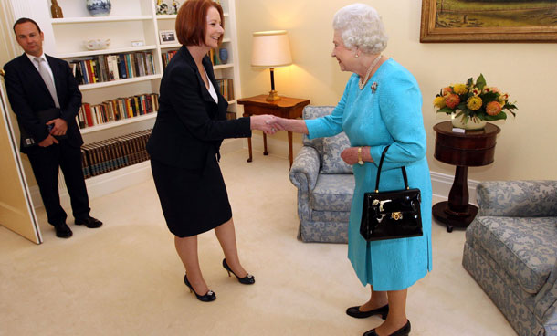 Australia's Prime Minister Julia Gillard, center left, shakes hands with Queen Elizabeth II as she enters a room in Government House in Canberra, Australia, Friday, Oct. 21, 2011. The Queen is on her first visit to Australia since 2006. (AP)