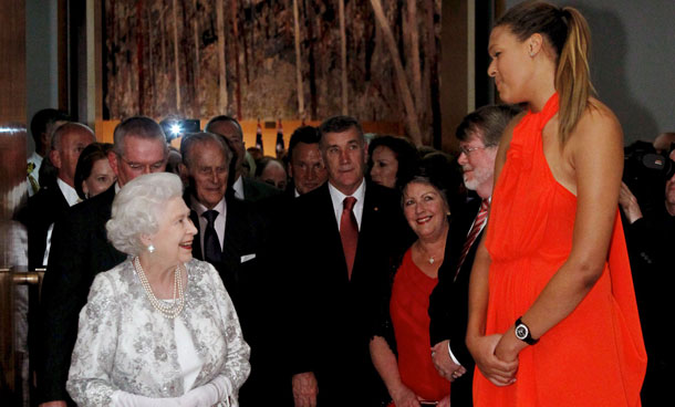 Queen Elizabeth II, left, meets Australian basketball player Liz Cambage, 6 ft 8 in (2.03 m) tall,  at a Parliamentary Reception at Parliament House in Canberra on Friday, Oct  21, 2011. (AP)