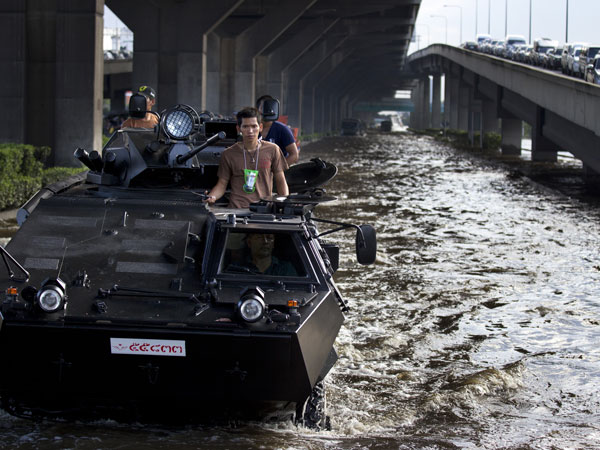 Thai military plow through the water into the flood zone in armored personnel carriers November 2, 2011 in Bangkok, Thailand. Thousands of flood victims have been forced to take shelter at crowded evacuation centers around the capitol city. (GETTY)