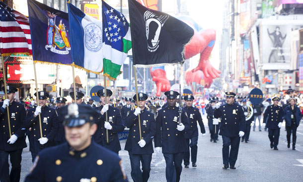 Members of the NYPD march through Times Square in Macy's Thanksgiving Day parade on November 24, 2011 in New York City. The 85th annual event is the second oldest Thanksgiving Day parade in the US. (AFP)