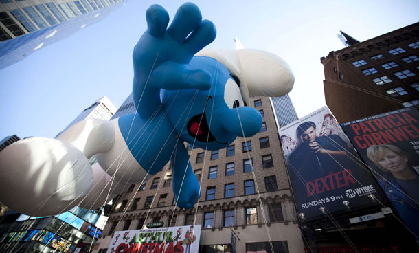 The Smurf balloon makes its way through Times Square in Macy's Thanksgiving Day parade on November 24, 2011 in New York City. The 85th annual event is the second oldest Thanksgiving Day parade in the US. (AFP)