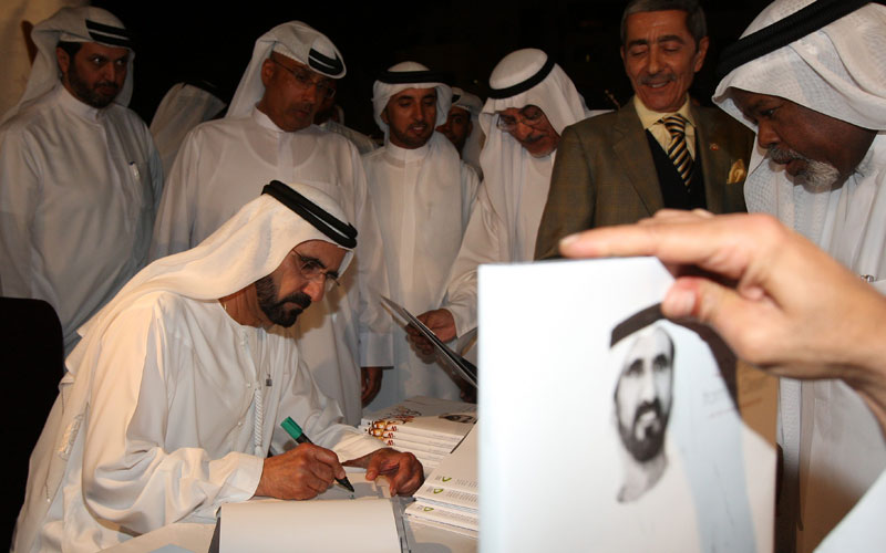 Sheikh Mohammed signing copies of the new book. Also seen is Ahmad Al Shaikh (Dennis B Mallari)