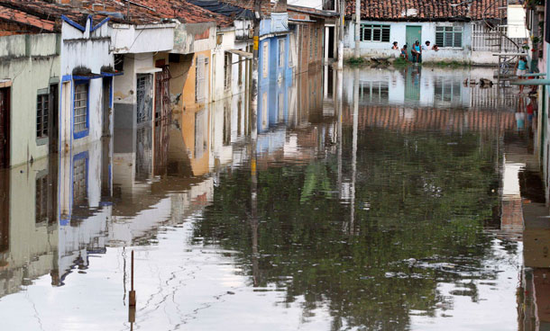 A view of houses in a flooded street in Cali December 5, 2011. At least 96 people have died as a result of heavy rains, authorities said. Colombia's weather office expects La Nina-related downpours to continue at least until the end of the first quarter of next year. (REUTERS)