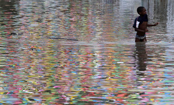 A boy walks in a flooded street in Cali December 5, 2011. At least 96 people have died as a result of heavy rains, authorities said. Colombia's weather office expects La Nina-related downpours to continue at least until the end of the first quarter of next year. (REUTERS)