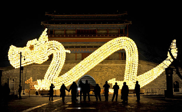 Visitors take pictures in front of a dragon-shaped lantern which has been set up for the upcoming Lunar New Year in Beijing, January 7, 2012. The Lunar New Year, or Spring Festival, begins on January 23 and marks the start of the Year of the Dragon, according to the Chinese zodiac.(REUTERS)