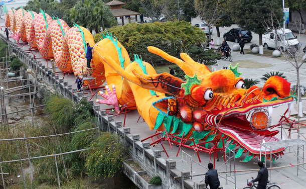 Workers decorate a dragon-shaped sculpture in preparation for a dragon dance which will involve more than 200 people during the upcoming Chinese New Year in Wenzhou, Zhejiang province January 9, 2012. The Lunar New Year, or Spring Festival, begins on January 23 and marks the start of the Year of the Dragon, according to the Chinese zodiac. (REUTERS)