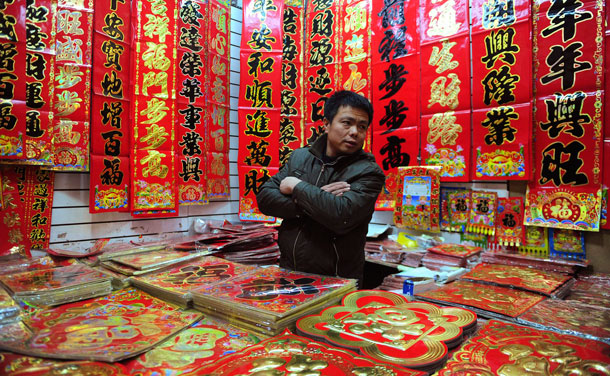 A vendor waits for customers at his stall selling couplets at a local market in Shenyang, Liaoning province January 13, 2012. The Lunar New Year, or Spring Festival, begins on January 23 and marks the start of the Year of the Dragon, according to the Chinese zodiac. (REUTERS)