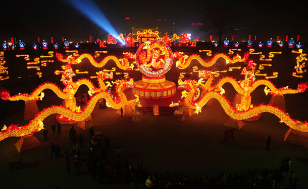 Visitors walk past dragon-shaped lanterns set up for the upcoming Spring Festival in Xi'an, Shaanxi province January 16, 2012.  The Lunar New Year, or Spring Festival, begins on January 23 and marks the start of the Year of the Dragon, according to the Chinese zodiac. Picture taken January 16, 2012. (REUTERS)