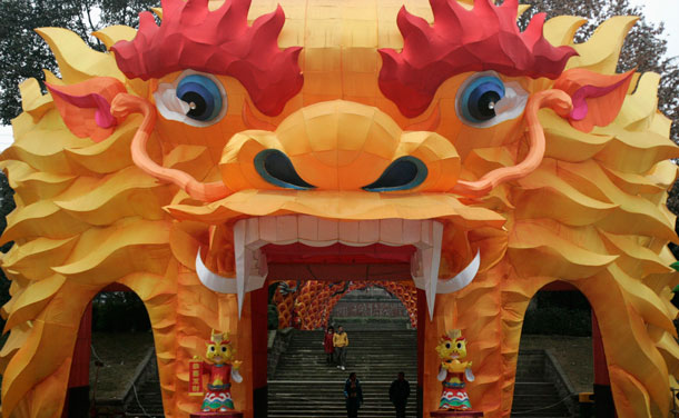 Pedestrians walk through a dragon-shaped arch lantern, which was set up for the upcoming Spring Festival, at a local park in Chengdu, Sichuan province January 15, 2012. (REUTERS)