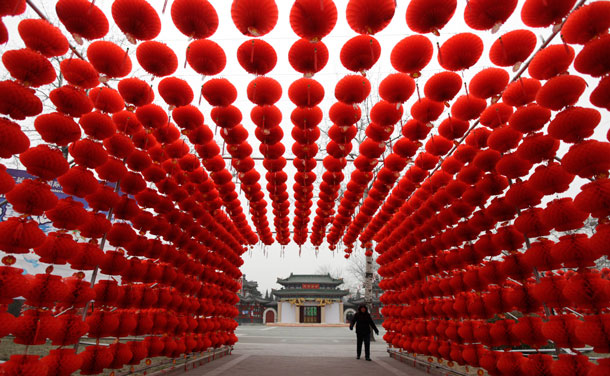 A woman walks past red lanterns, which were put up as decoration for an upcoming temple fair, at an entrance of Longtan park in Beijing January 16, 2012. The Lunar New Year, or Spring Festival, begins on January 23 and marks the start of the Year of the Dragon, according to the Chinese zodiac. (REUTERS)